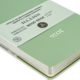 Green notebook with a close-up of the cover displaying the year 2026. 