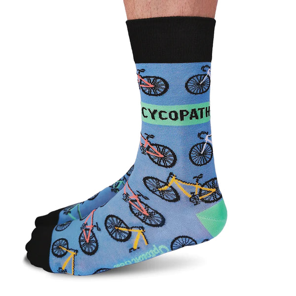 A pair of colorful socks with bicycle patterns and the text 'CYCOPATH' on the side, worn on a person's foot.