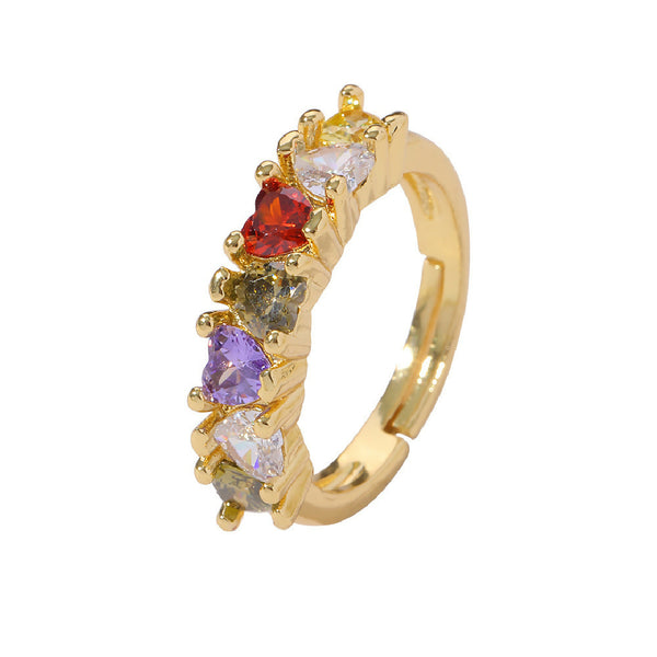 Gold ring with multicolored gemstones on a white background