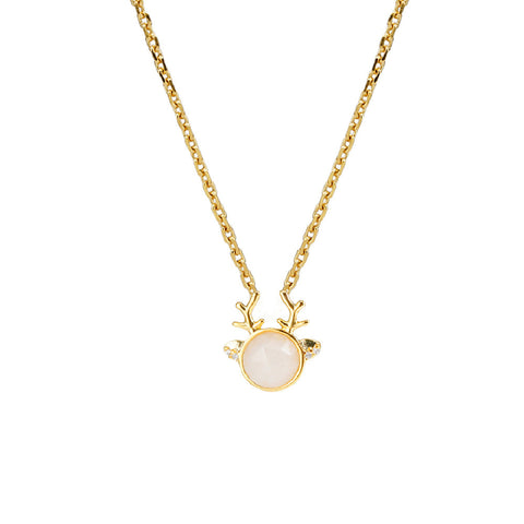 Gold necklace with reindeer antlers and a round pendant on a white background