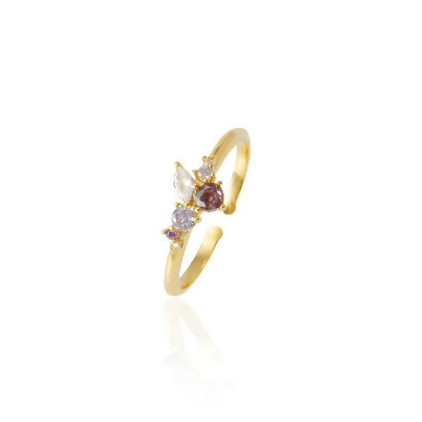 Gold ring with embedded gemstones on a white background