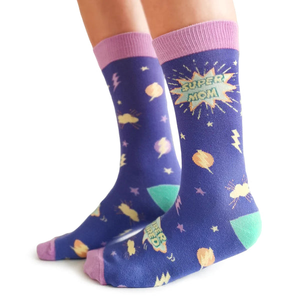 A pair of socks with the phrase 'Super Mom' printed on them, featuring a purple background with yellow and green accents and star patterns.